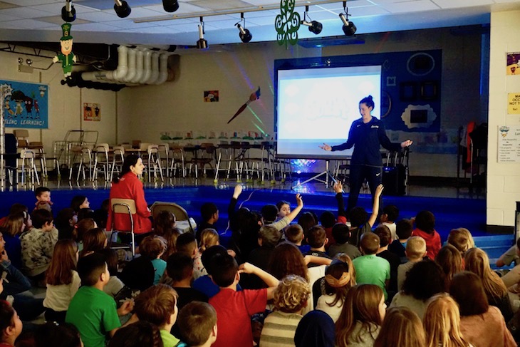 <p>A Boosterthon team member during a “huddle” meeting with students and staff.</p>
